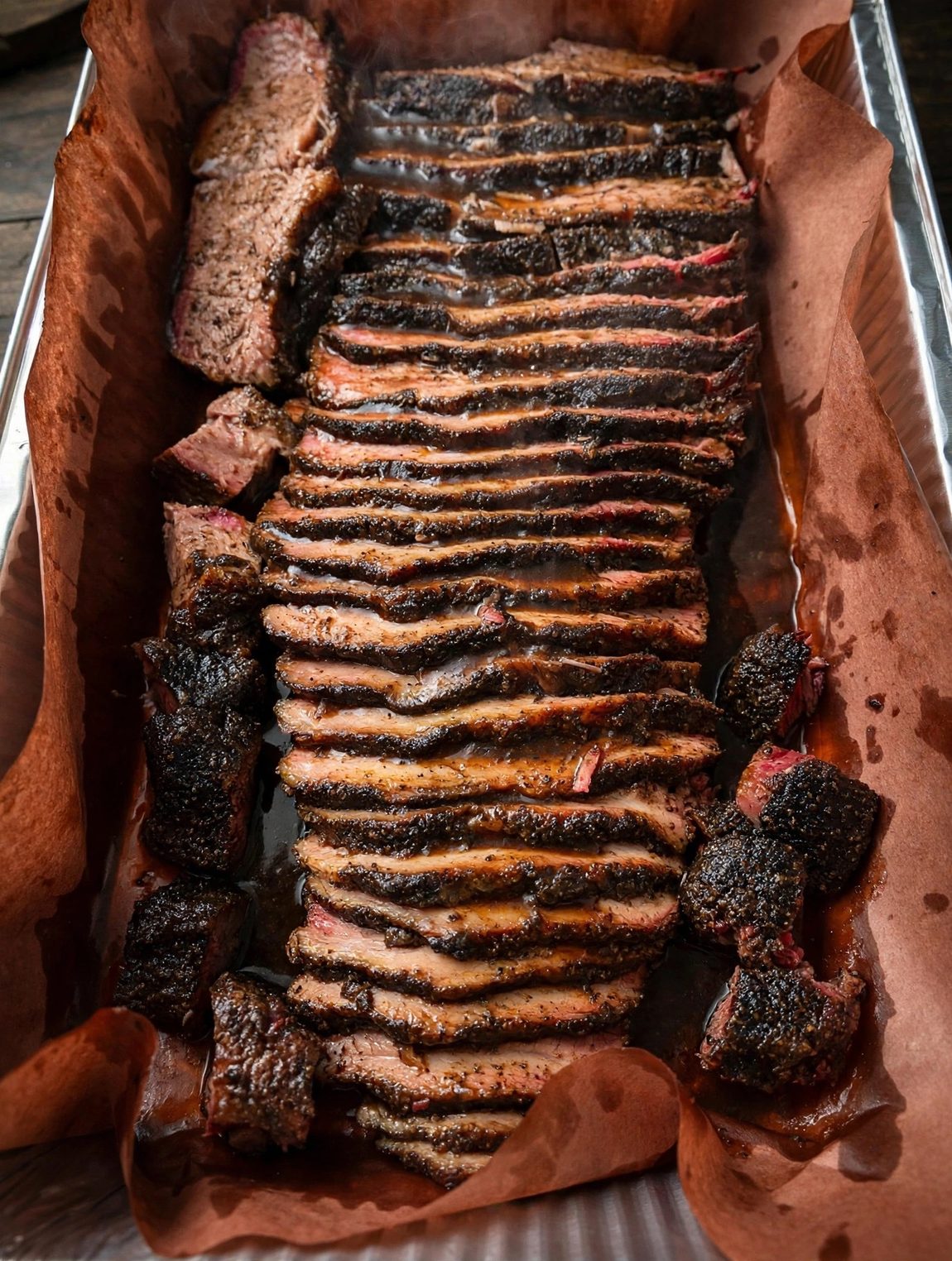 Tray of freshly sliced smoked brisket